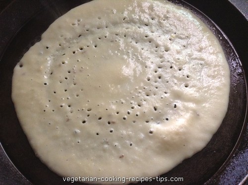 xaadai yadni moong dal dosa batter spread on tava 500x373.jpg.pagespeed.ic.w4wtuu8ho1