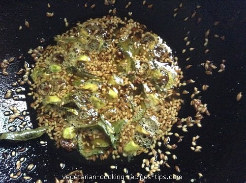tempering sesame thin poha chivda 500x373